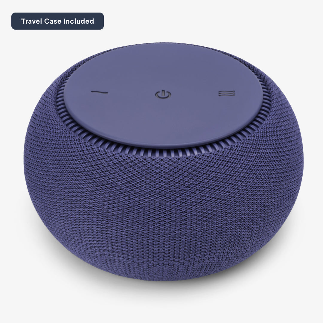 Round blue fabric-covered portable speaker with control buttons on top.